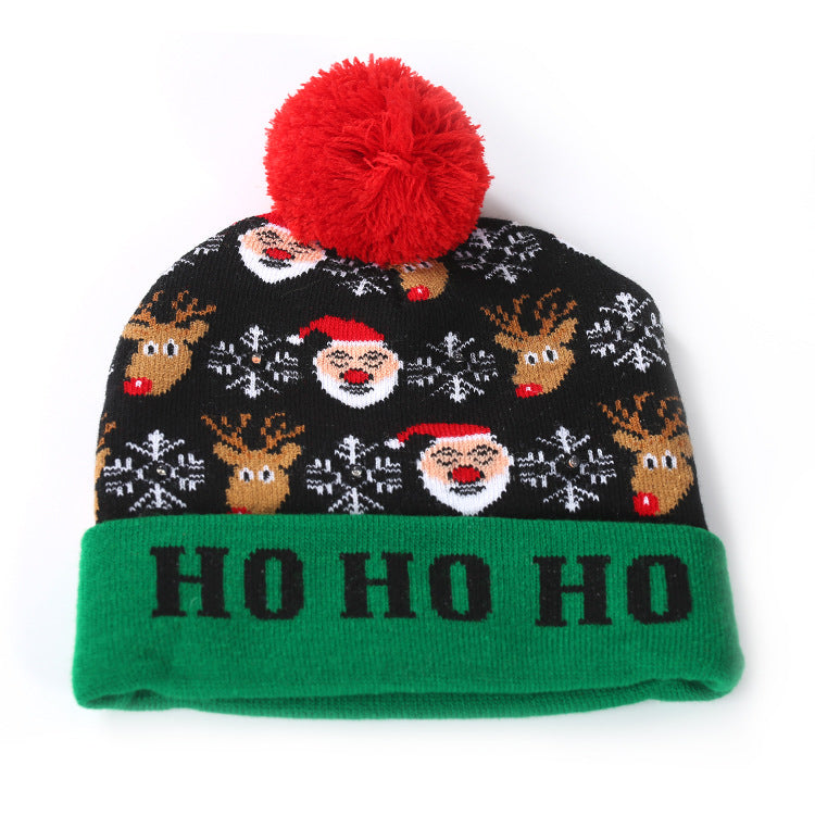 Knitted light-up Christmas beanie with a lettered turn-up and big pompom - black santa and reindeer