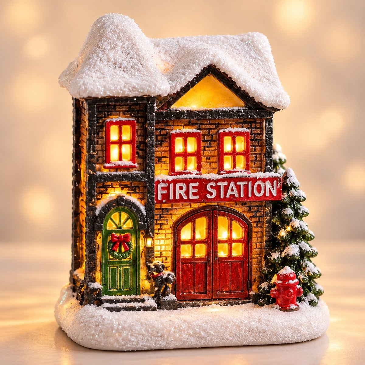 Light-up Christmas house with snow on the roof - fire station