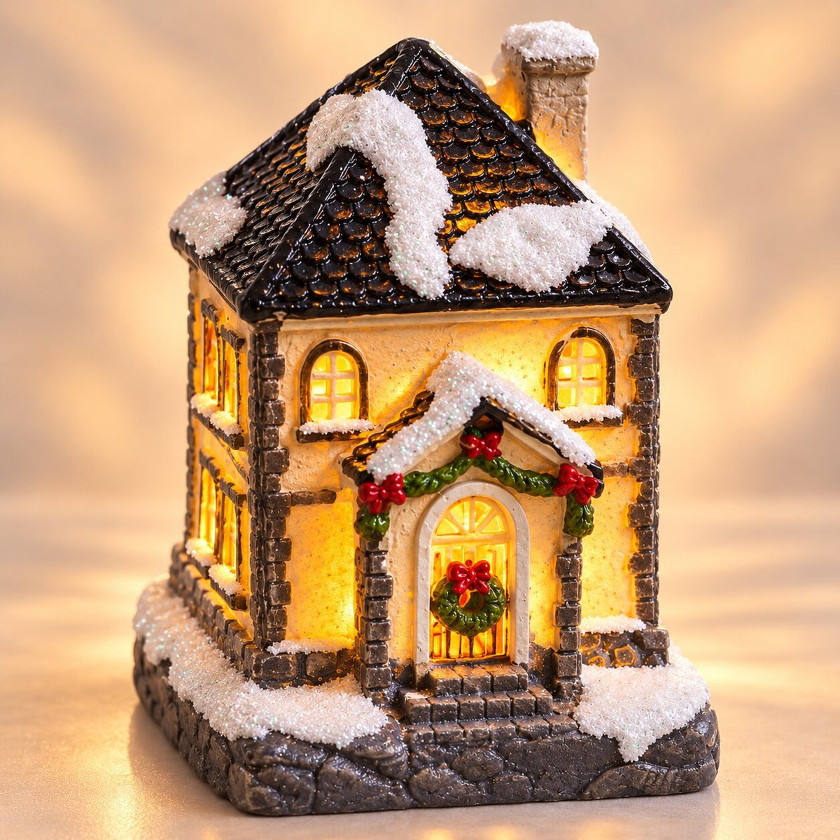 Light-up Christmas house with snow on the roof - winter house