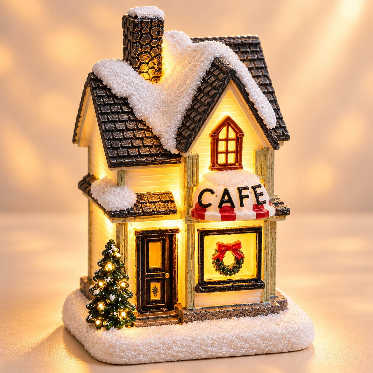 Light-up Christmas house with snow on the roof - winter café