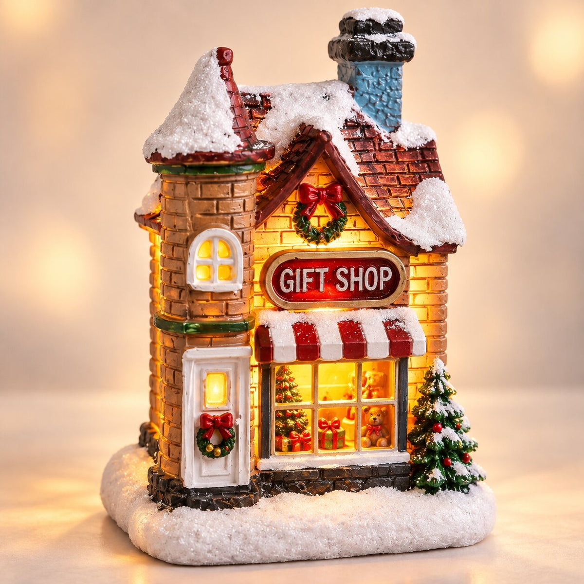 Light-up Christmas house with snow on the roof - gift shop