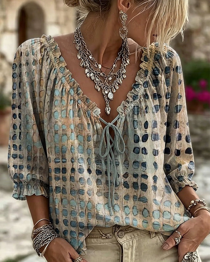 Loose polka dot blouse with a ruffled V-neck and tie cord - beige and blue