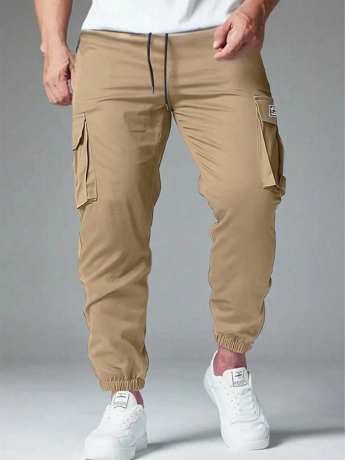 Cargo trousers for men with a drawcord waist, thigh flap pockets and elastic cuffs at the ankle - sand