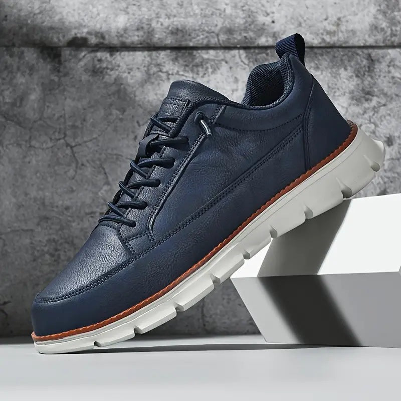 Men's smooth faux leather trainers with a flexible grooved sole and tan welt - navy