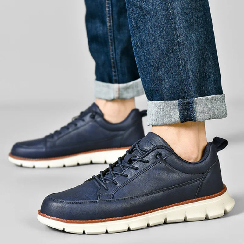Men's smooth faux leather trainers with a flexible grooved sole and tan welt - view 2