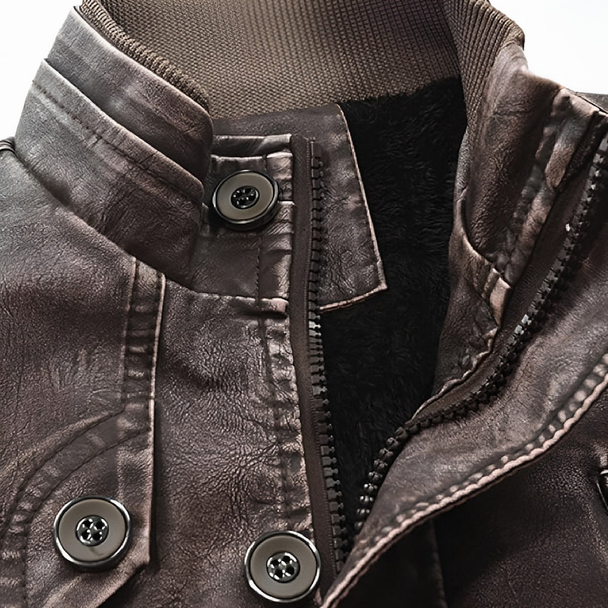 Close-up of the stand collar, zip and fleece lining of the brown leather jacket