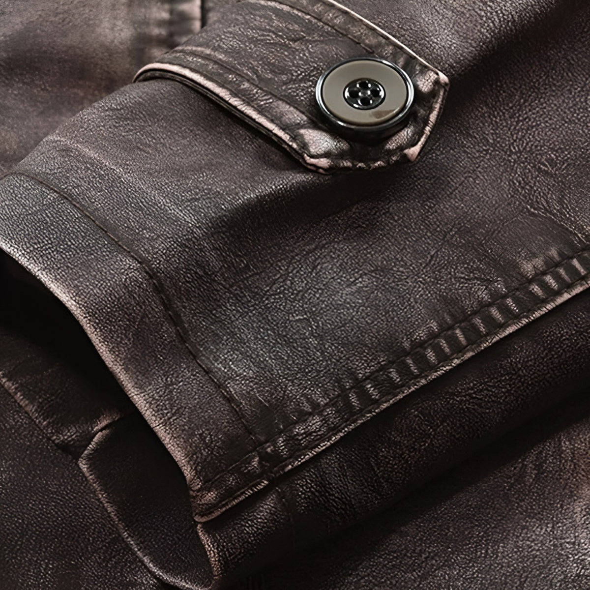 Close-up of the cuff with button tab on the leather jacket