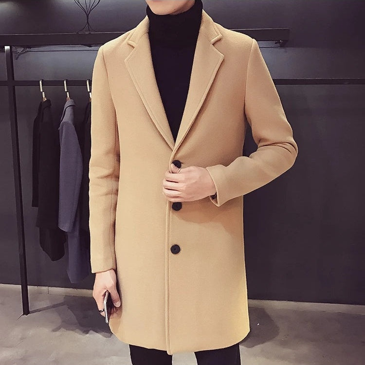 Men's camel longline coat worn over a black roll neck