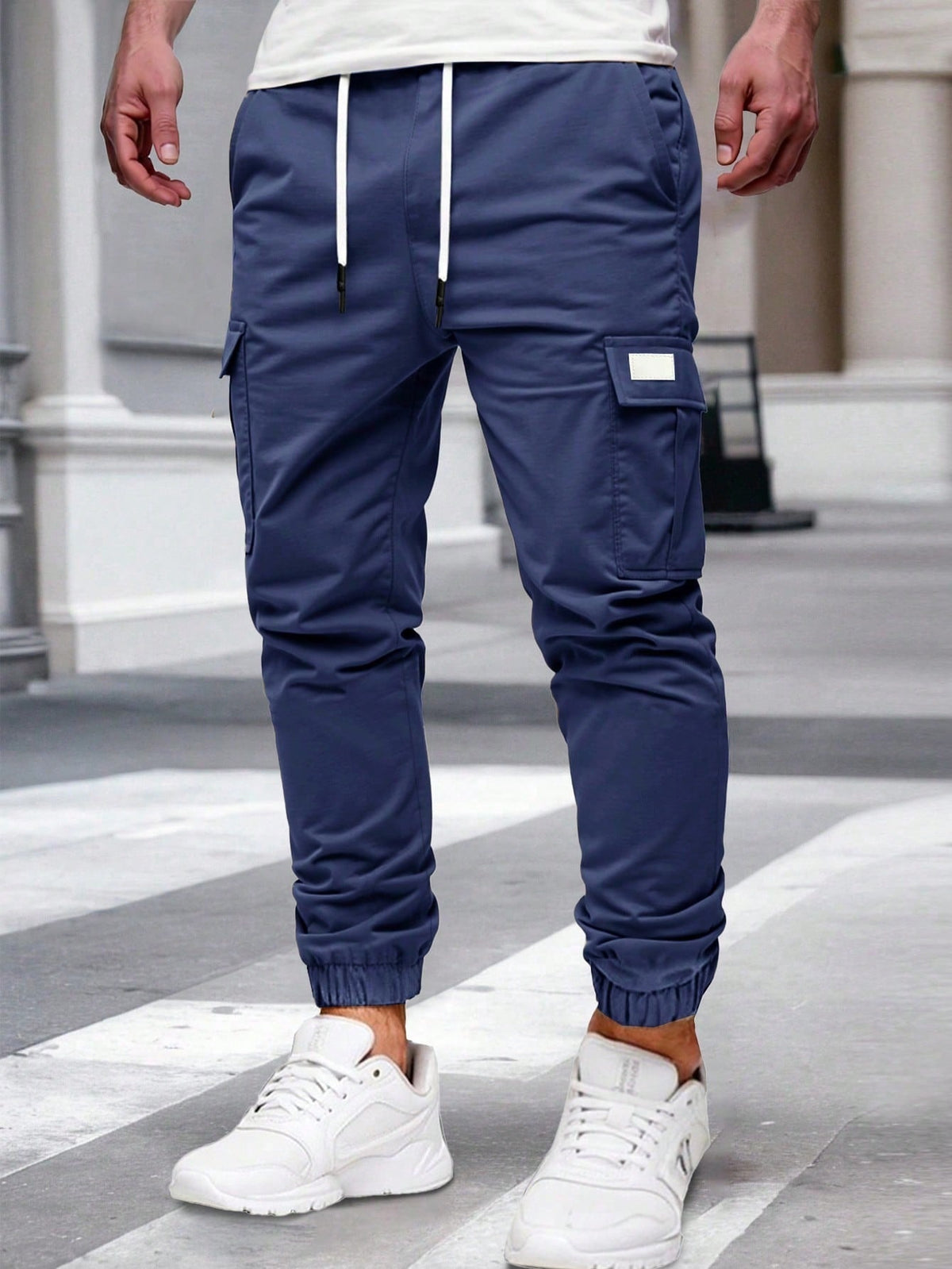 Relaxed cargo joggers for men with a drawcord waist, thigh flap pockets and cuffed ankles - navy