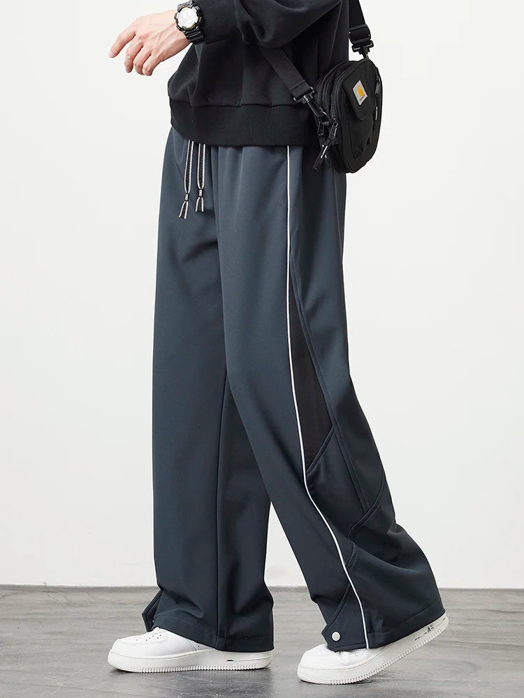 Men's wide-leg track trousers with white piping, a contrast panel on the lower leg and popper hems - slate grey