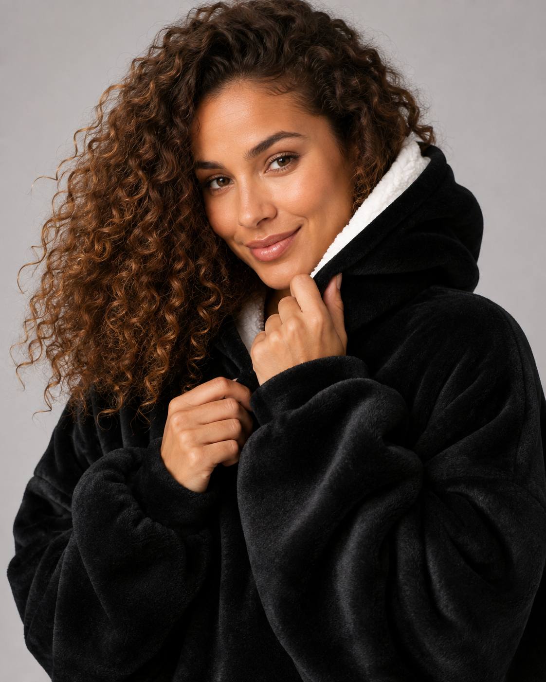 Oversized black blanket hoodie with a lined hood and full width pocket