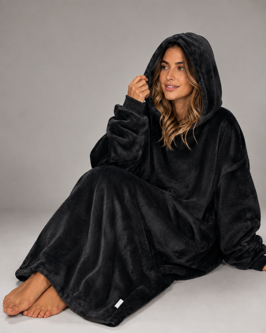 Oversized black blanket hoodie with a lined hood and full width pocket