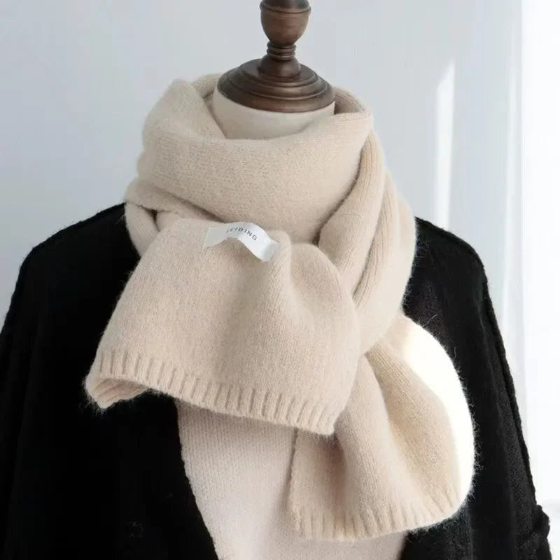 Women's narrow knitted scarf with ribbed ends and a small white label - cream