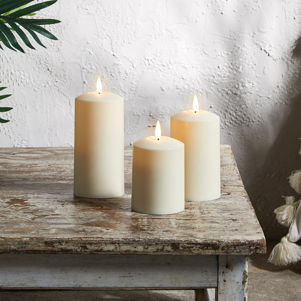Three ivory outdoor LED candles with a flickering flame and timer