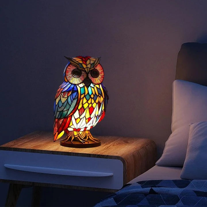 Owl lamp in a stained glass look with red, blue and yellow panels on a round base