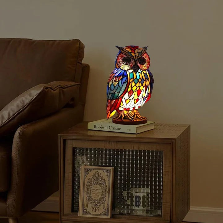 Owl lamp in a stained glass look with red, blue and yellow panels on a round base