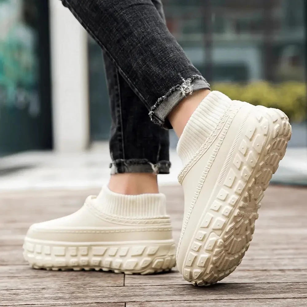 Platform slippers with a chunky tread sole, smooth upper and plush lining