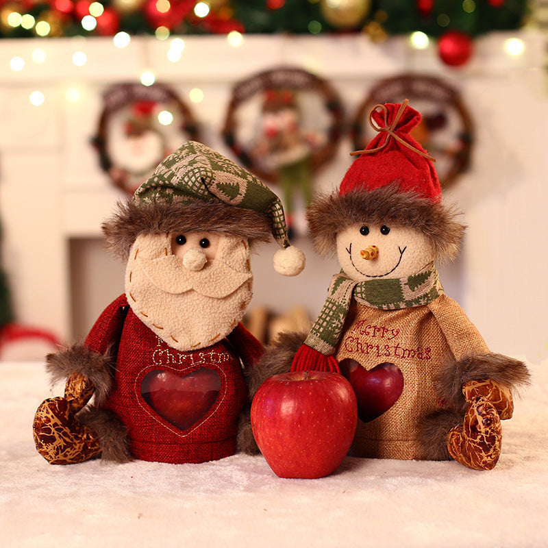 Seated plush Christmas figure with hat, scarf and a heart-shaped window in the body