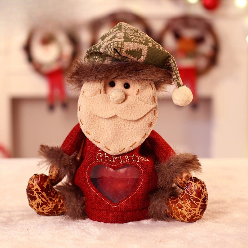 Seated plush Christmas figure with hat, scarf and a heart-shaped window in the body - father christmas