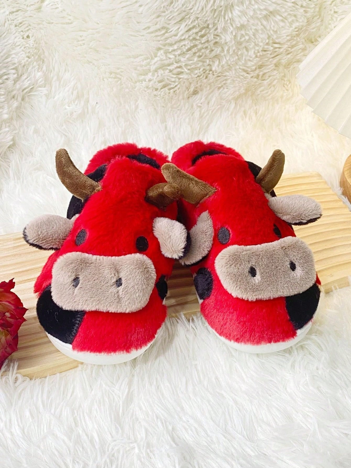 Plush cow slippers with little horns, ears and a snout on the toe and spots on the sides - red