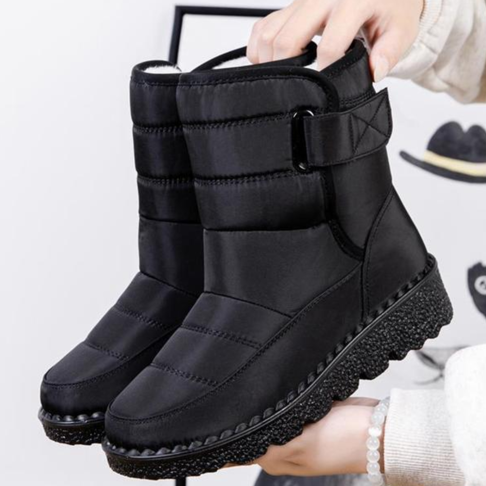 Women's quilted snow boots with a hook-and-loop strap and plush lining