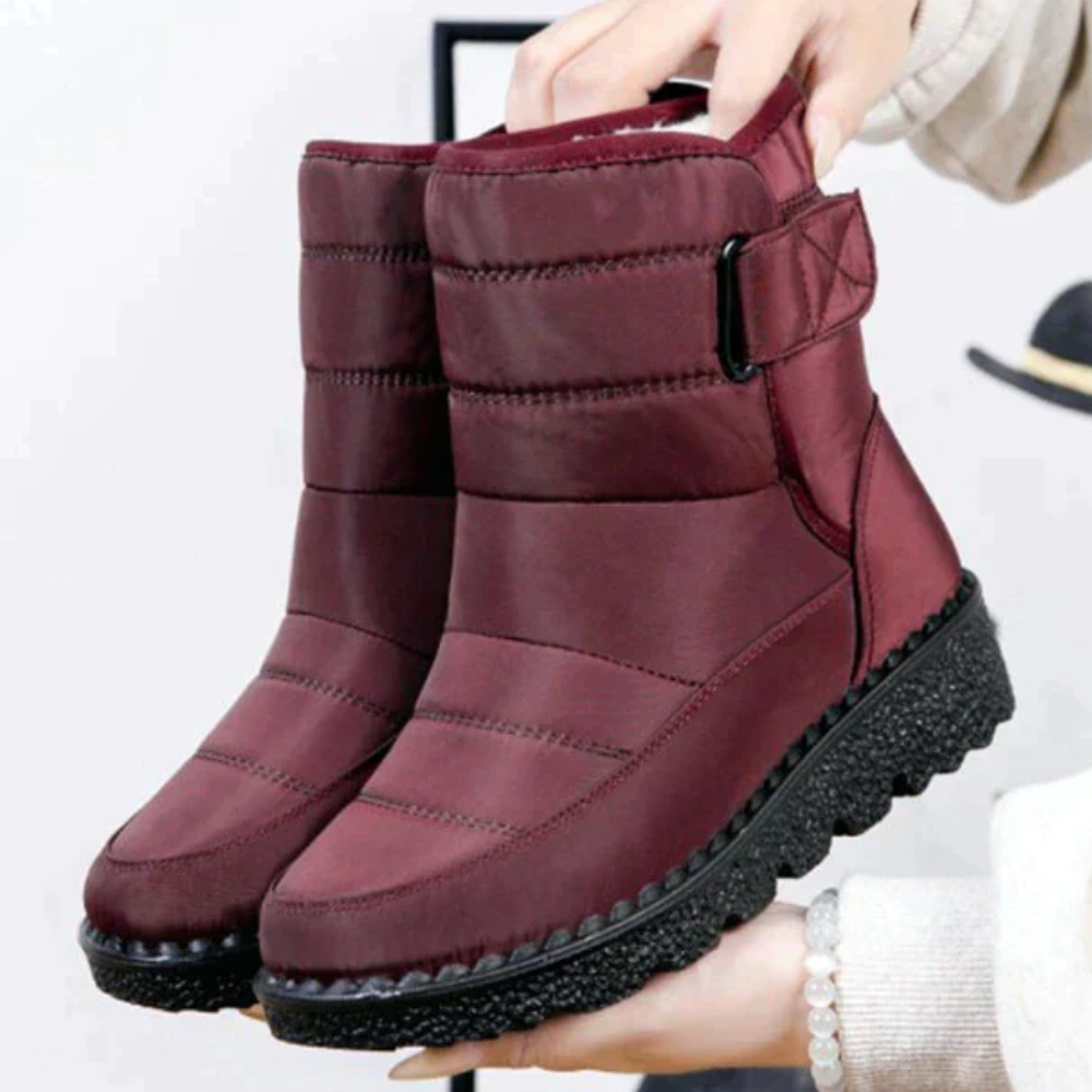 Women's quilted snow boots with a hook-and-loop strap and plush lining