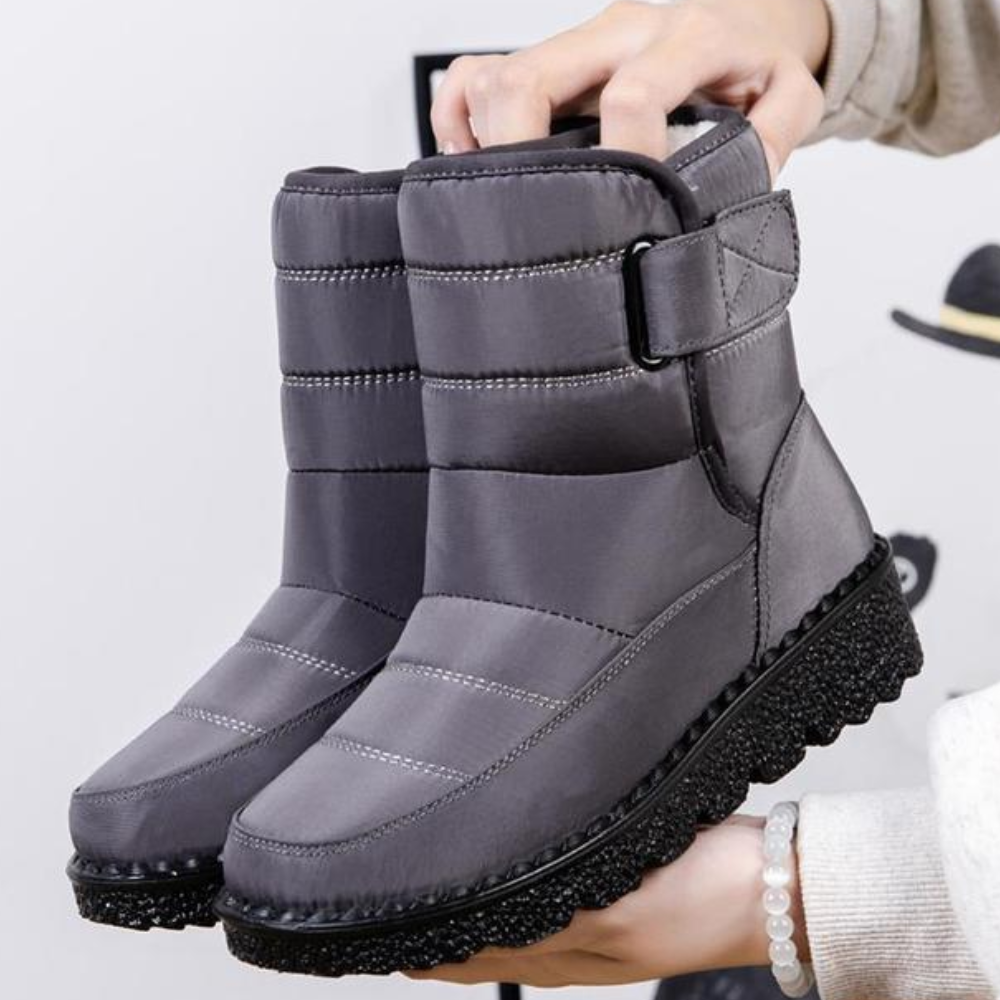 Women's quilted snow boots with a hook-and-loop strap and plush lining
