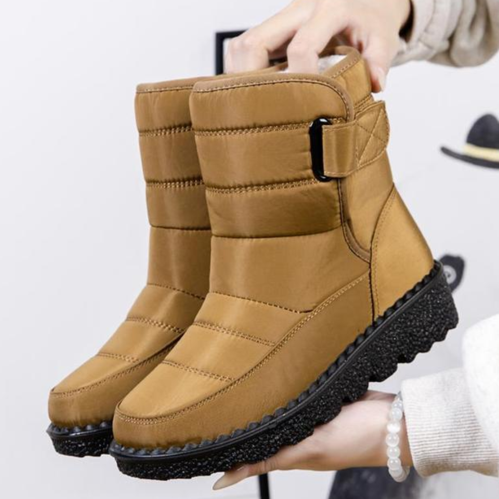 Women's quilted snow boots with a hook-and-loop strap and plush lining
