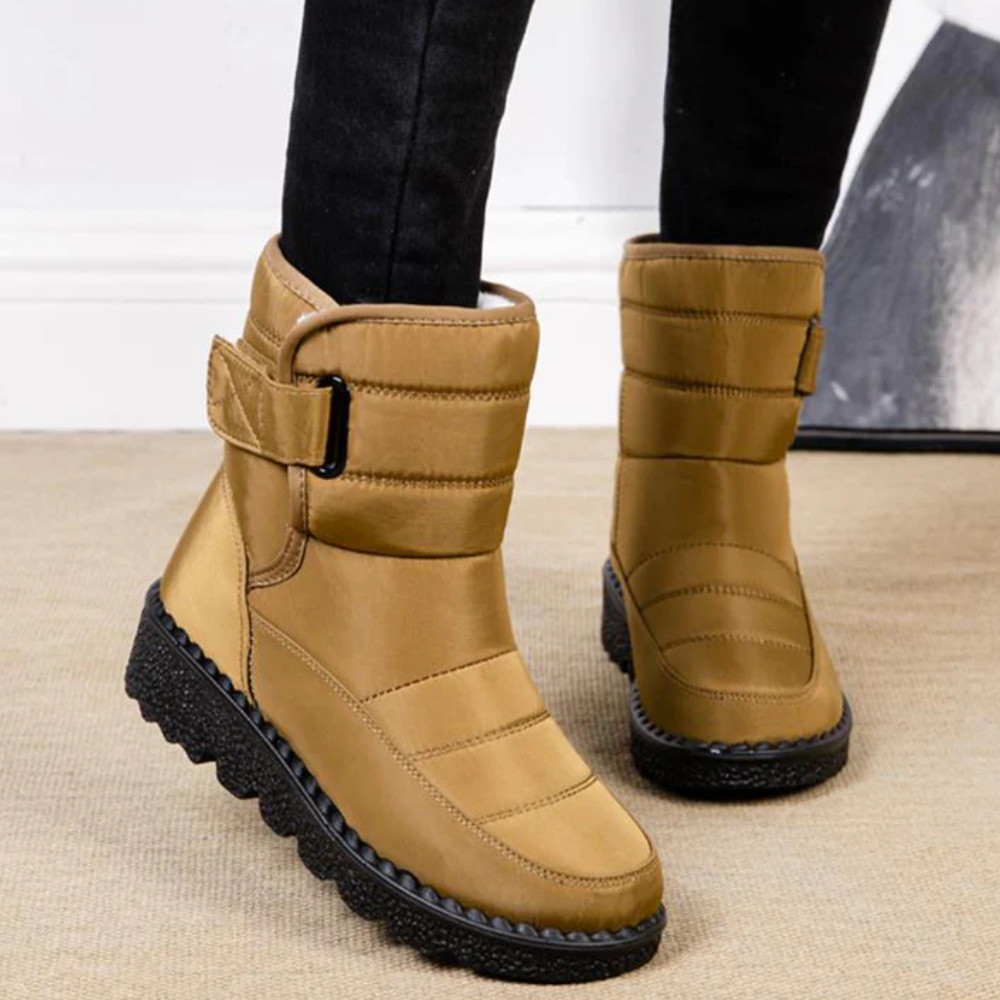 Women's quilted snow boots with a hook-and-loop strap and plush lining