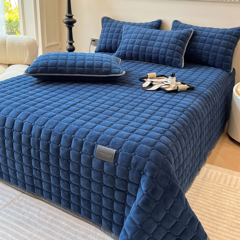 Quilted teddy bedspread with a square pattern on a double bed - dark blue