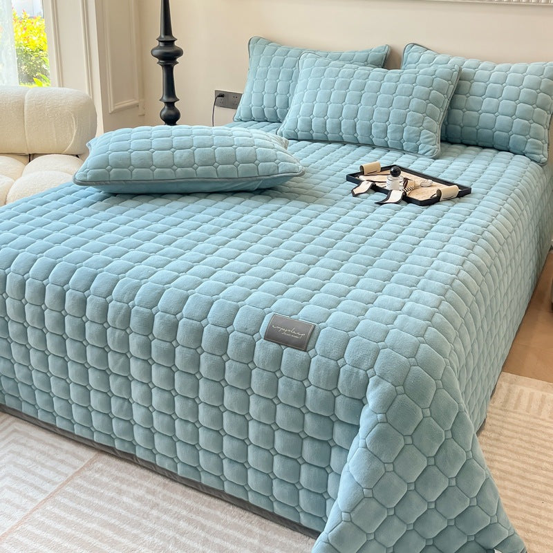 Quilted teddy bedspread with a square pattern on a double bed - light blue