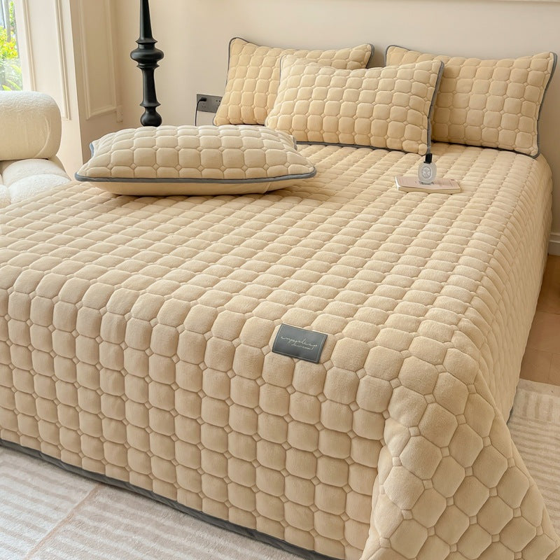 Quilted teddy bedspread with a square pattern on a double bed - sand