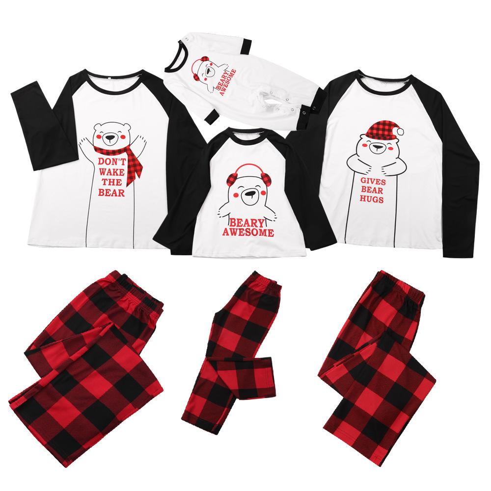Family Christmas pyjamas with a polar bear slogan top and red and black check bottoms