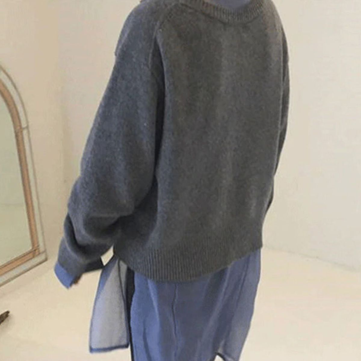 Women's relaxed knit cardigan with a round neck and asymmetric button front