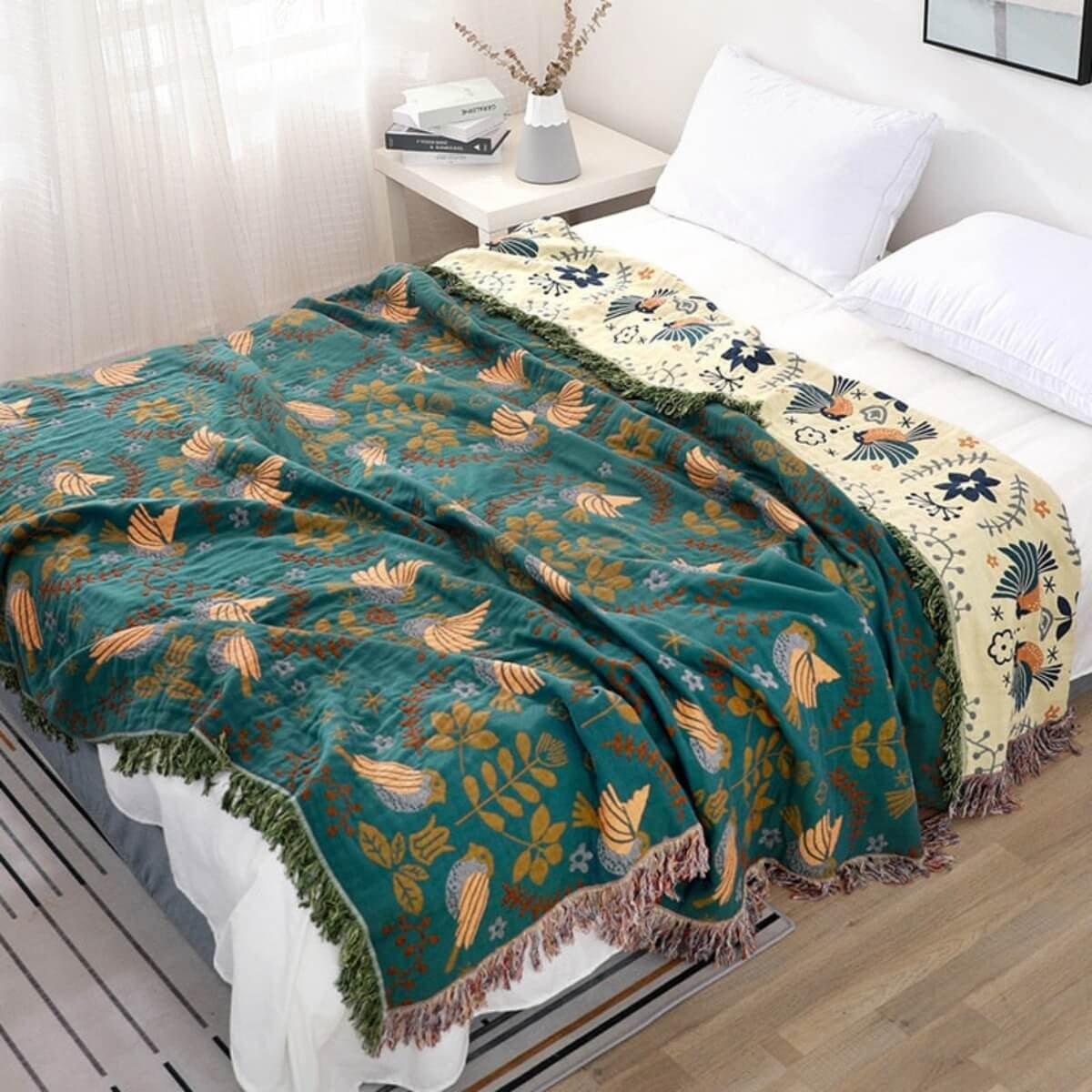Reversible cotton throw with a bird pattern and tassels over a sofa - view 2