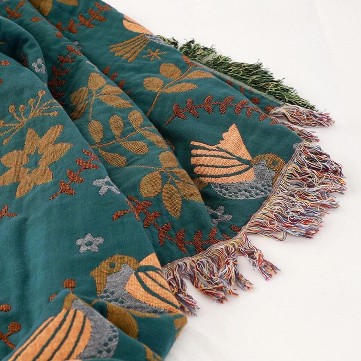 Reversible cotton throw with a bird pattern and tassels over a sofa - view 4