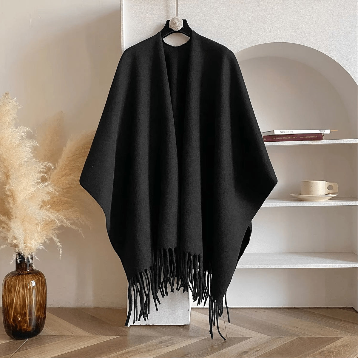 Reversible women's poncho in soft knit with fringe on a hanger - black