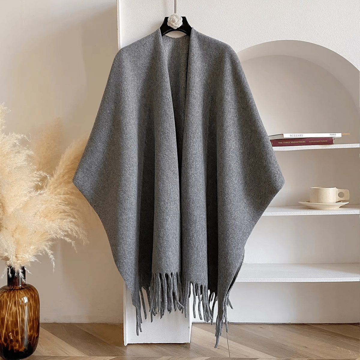 Reversible women's poncho in soft knit with fringe on a hanger - grey