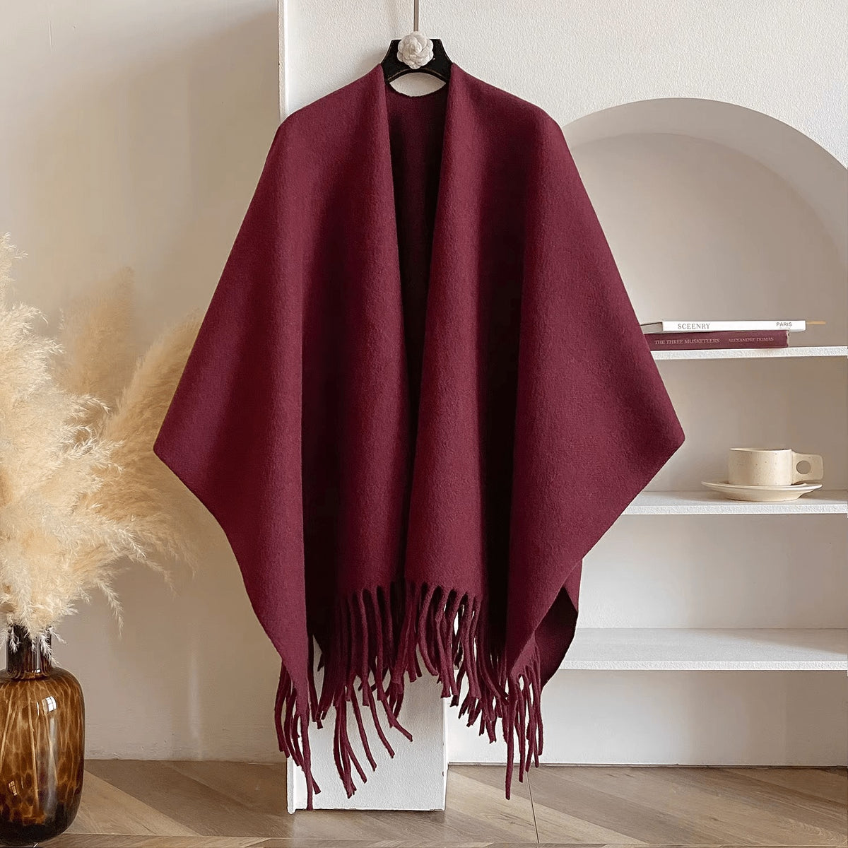 Reversible women's poncho in soft knit with fringe on a hanger - burgundy