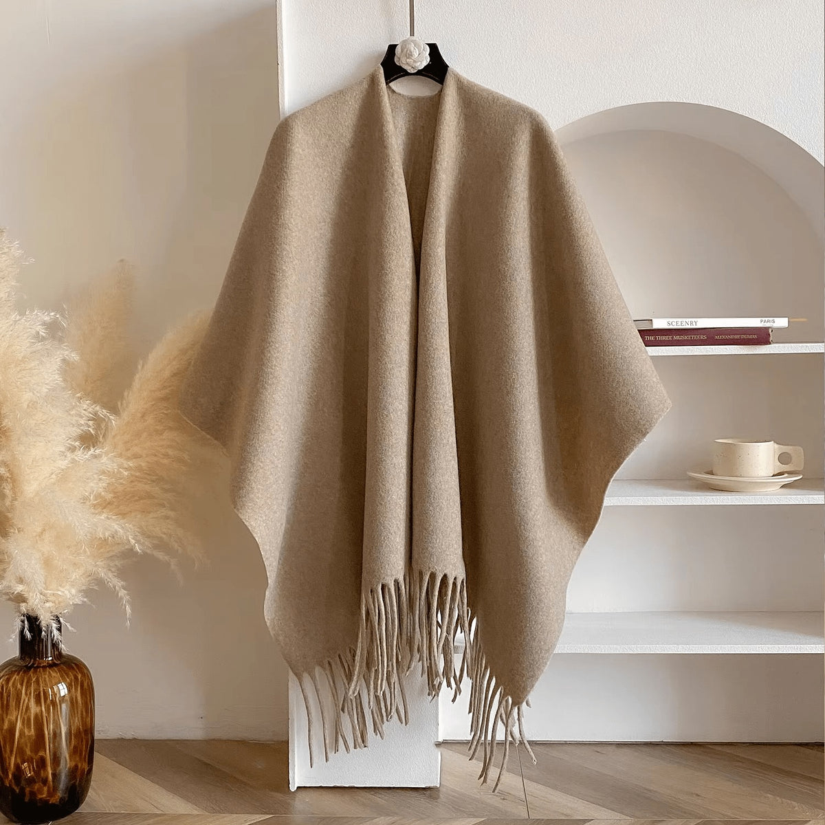 Reversible women's poncho in soft knit with fringe on a hanger - sand beige