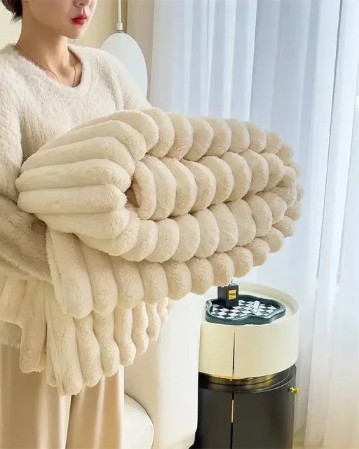 Ribbed faux fur blanket over a sofa - cream
