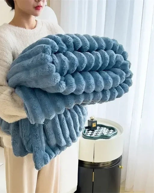 Ribbed faux fur blanket over a sofa - blue