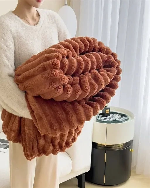 Ribbed faux fur blanket over a sofa - rust brown