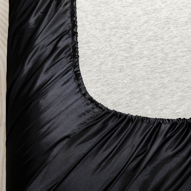 Satin sheet set with fitted sheet, flat sheet and two pillowcases on a bed - view 2