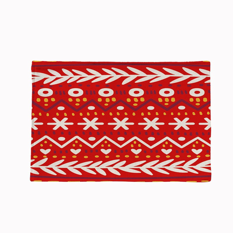 Set of four Christmas placemats with a festive print on a laid table - red and white nordic pattern