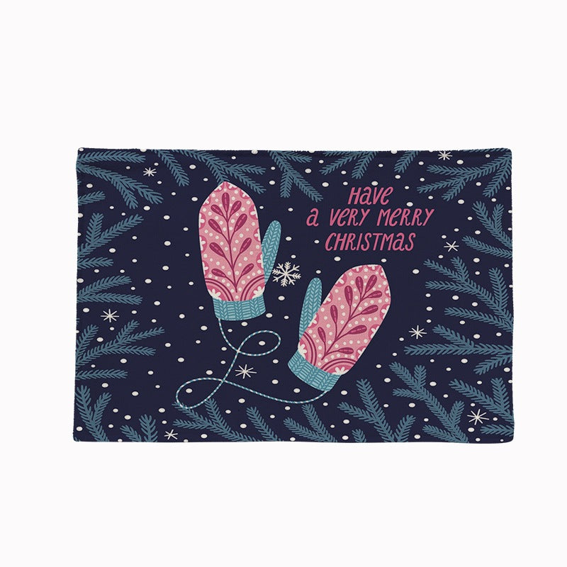 Set of four Christmas placemats with a festive print on a laid table - mittens on navy