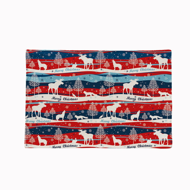 Set of four Christmas placemats with a festive print on a laid table - striped reindeer