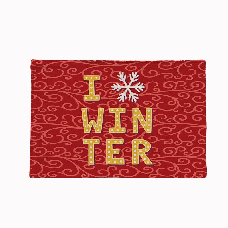 Set of four Christmas placemats with a festive print on a laid table - winter lettering on red