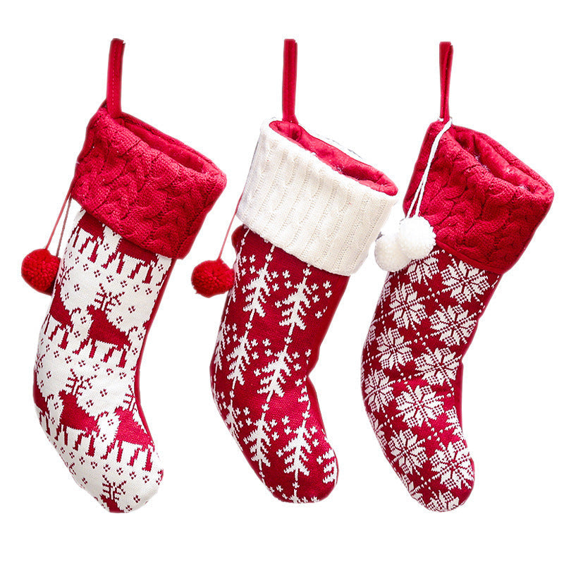 Set of four knitted Christmas stockings with cable cuffs, pompoms and Nordic patterns