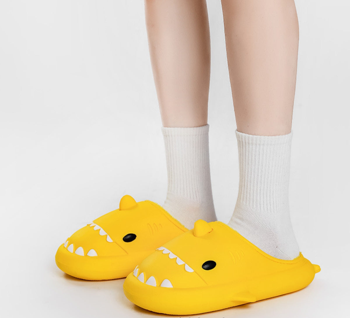 Slippers shaped like a shark's head with teeth, eyes, a fin and plush lining - yellow